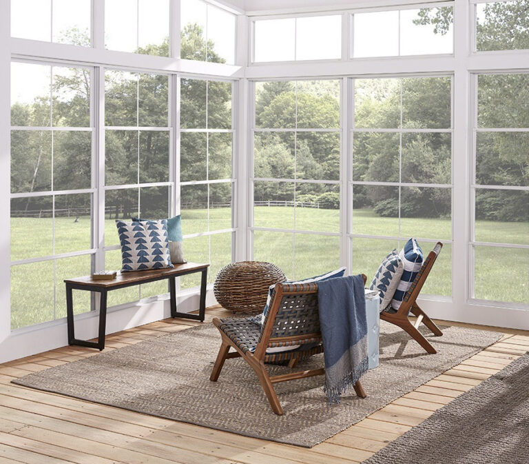 Two chairs facing outside in an enclosed patio